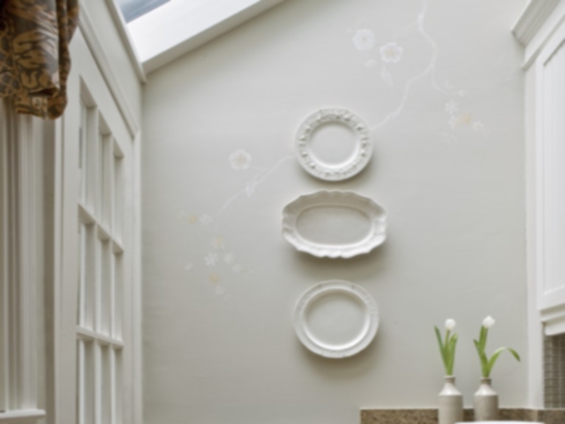Stylized Botanical Mural in kitchen with white plates as artwork.