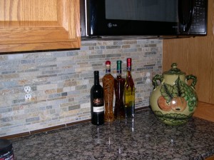 Painted outlet covers for stone backsplash