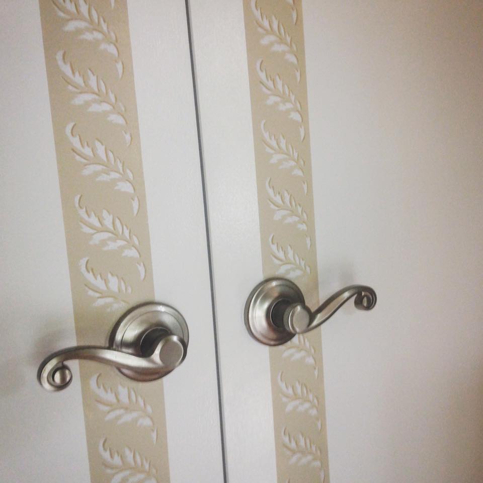 Boiserie borders add architectural details to these doors. Hand painted with leaf border in creams and white. Interior design by Danziger Design Group